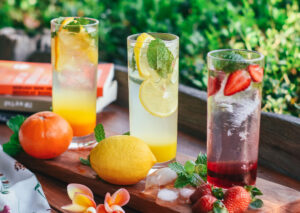 A wooden table topped with glasses filled with drinks