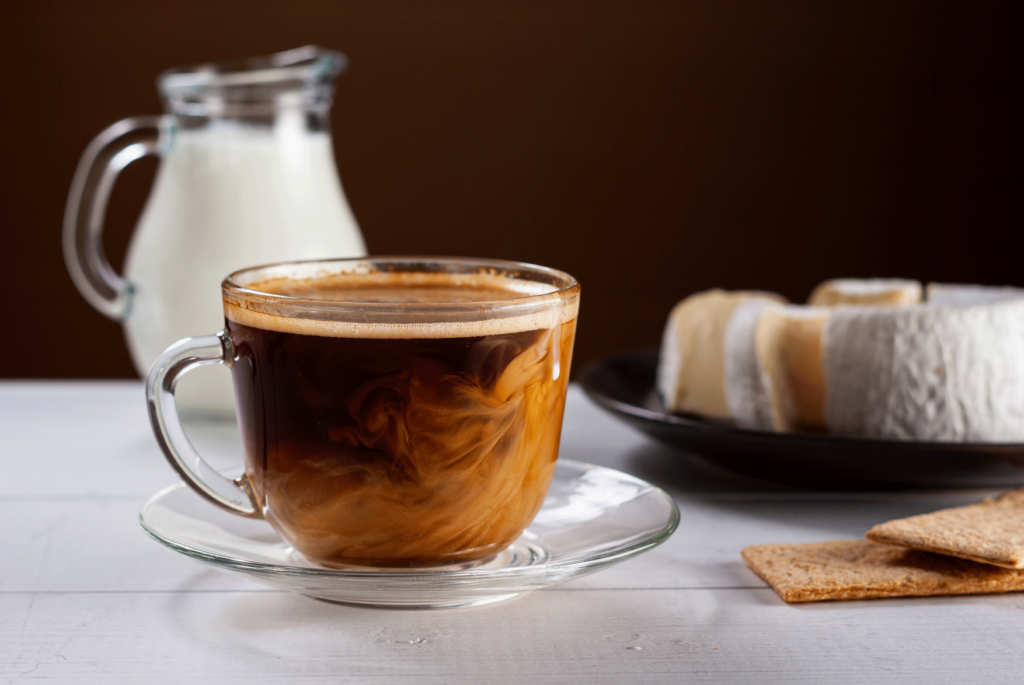 A cup of hot coffee sitting on top of a saucer, ready for foodservice operators