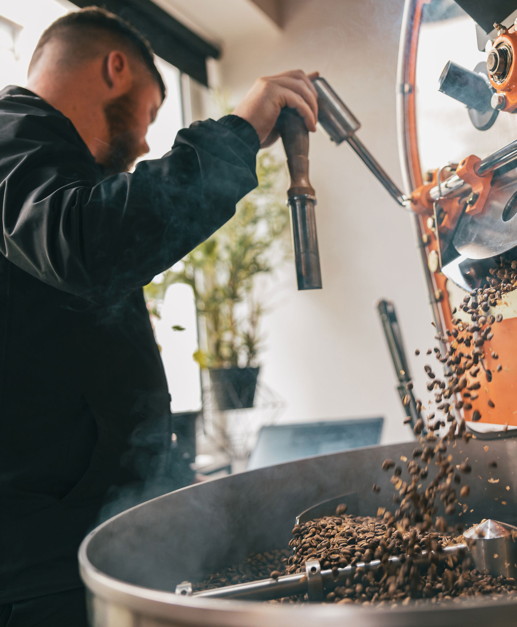 a man pouring coffee into a large pot