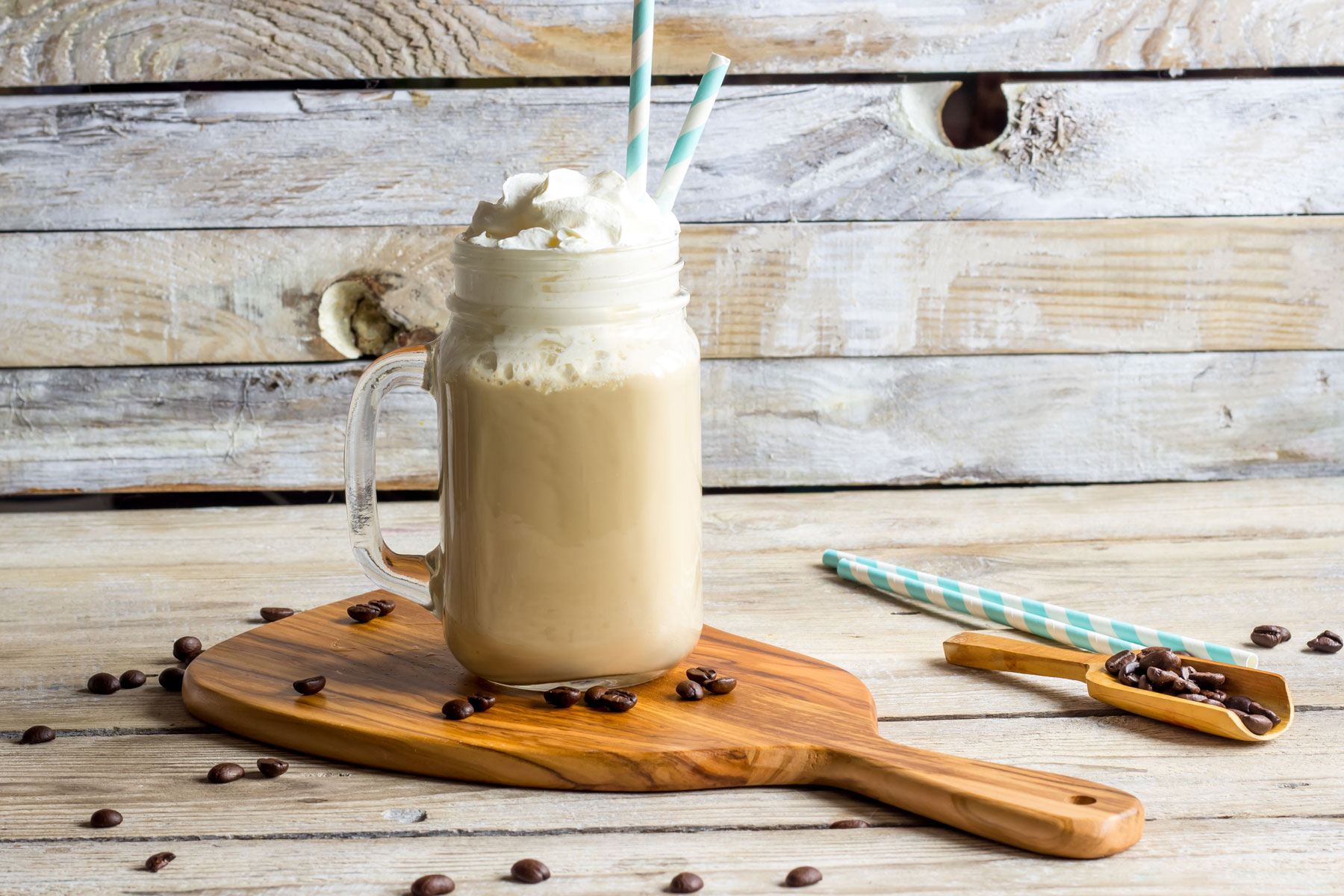 A cup of coffee with whipped cream and chocolate chips