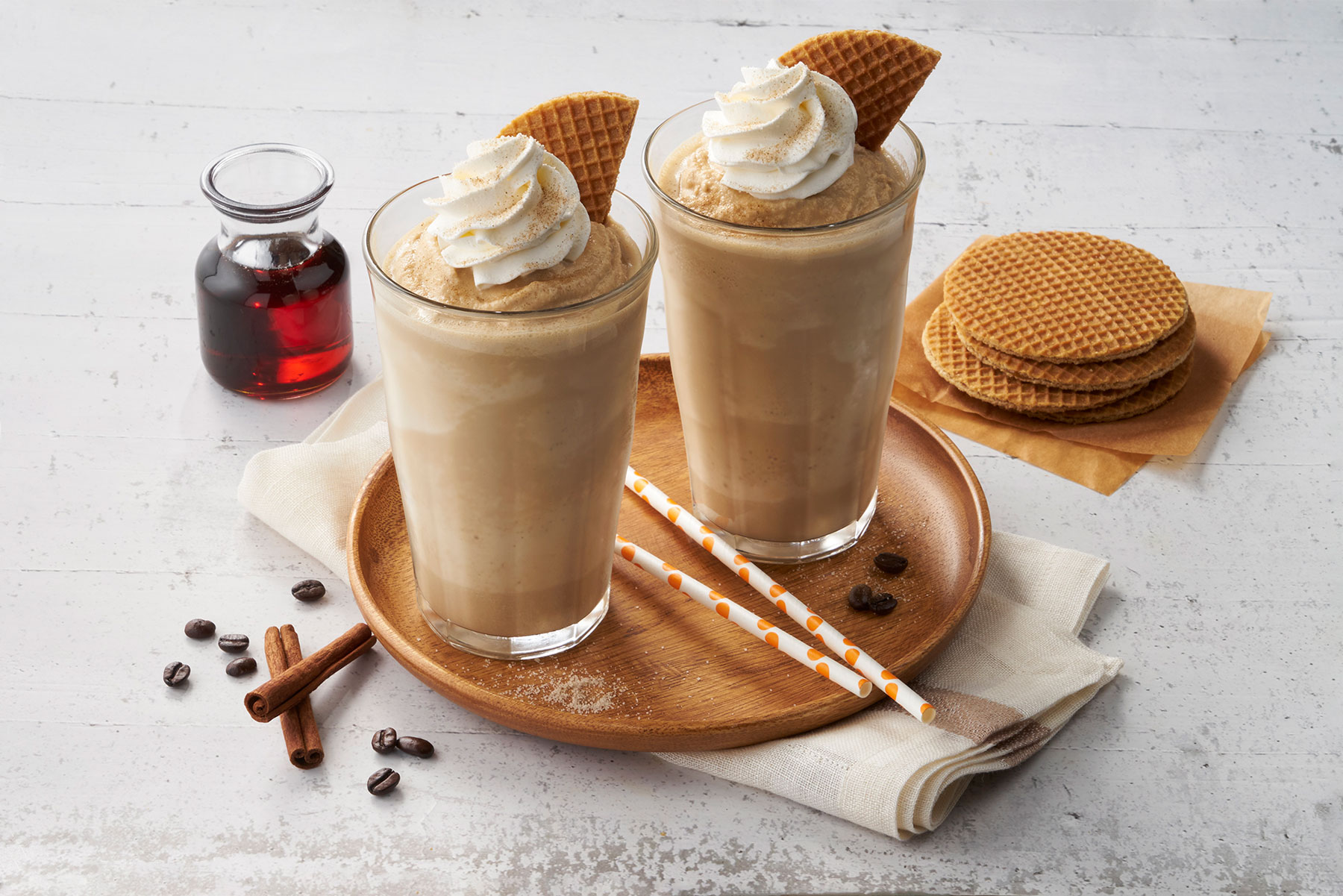 A plate with a couple of glasses of ice cream