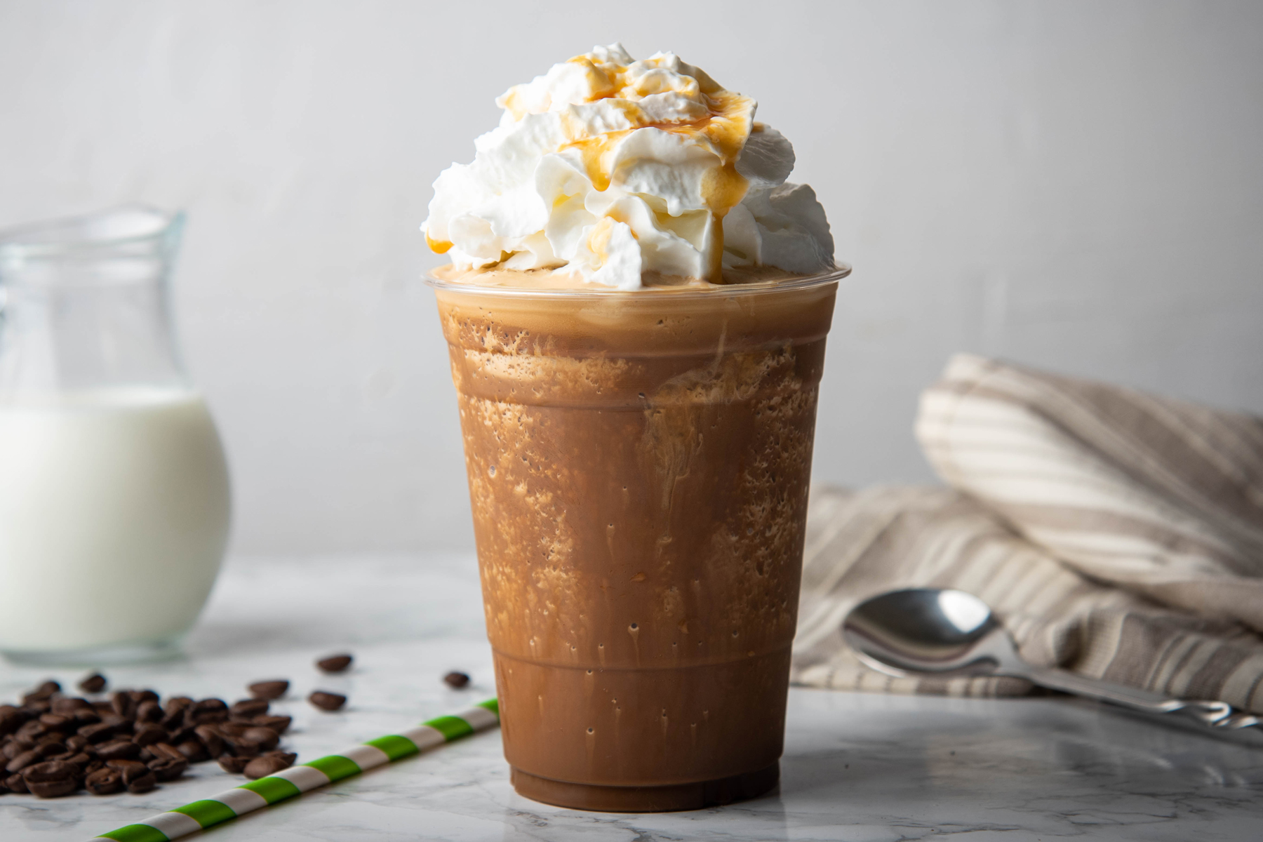 A delicious chocolate milkshake topped with whipped cream and garnished with coffee beans