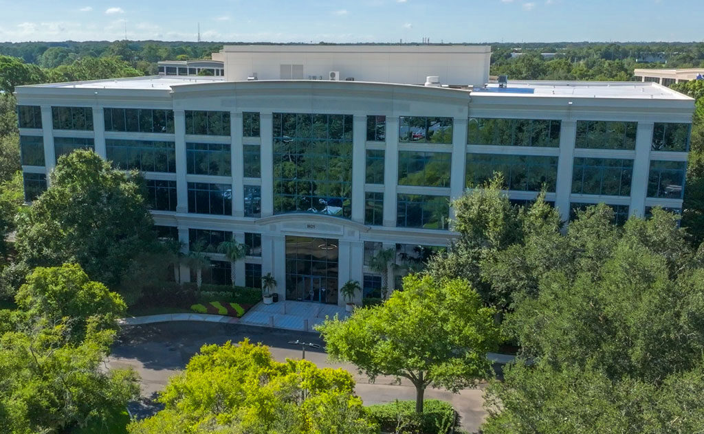 aerial view of a large building surrounded by trees